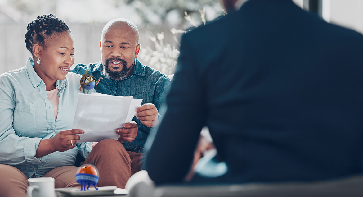 couple smiling looking over documents