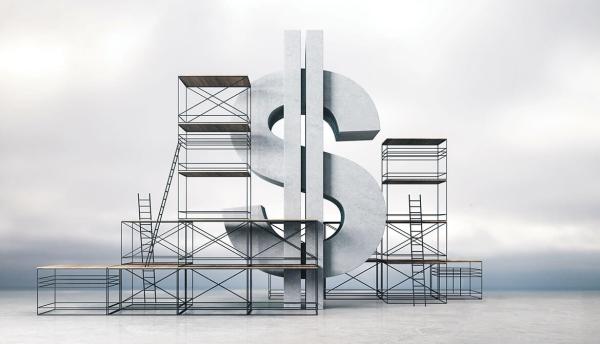 stone dollar sign surrounded by scaffolding in front of cloudy sky