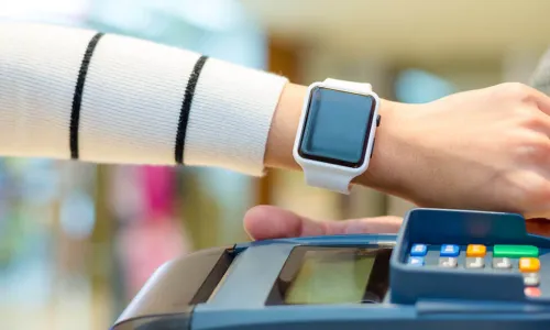 woman paying using her Apple Watch to pay