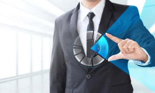 Businessman interacting with a holographic pie chart signifying market share and growth