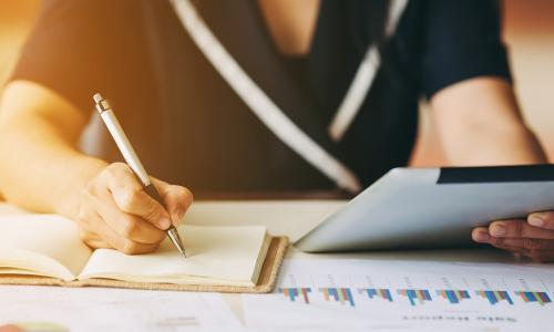 business woman surrounded by financial reports doing an analysis