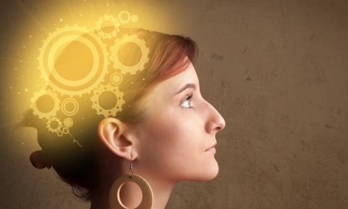 woman with glowing cogs in her brain illustrates neuroscience and employee motivation
