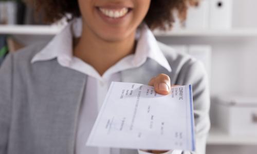 female executive receiving her paycheck as compensation for her work