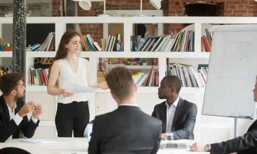 Female business manager coaching a group of employees