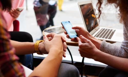 friends use an Apple phone to pay