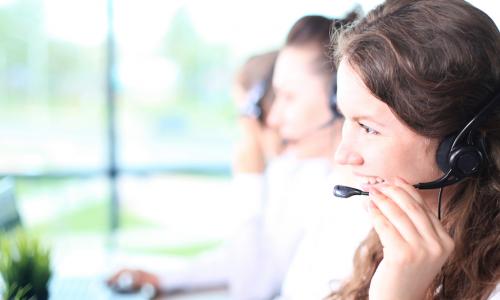 woman with headset on smiling