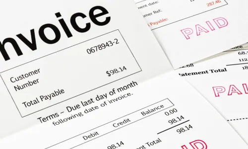 Invoices with PAID stamped on them in red ink