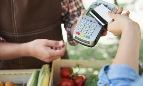 customer using a contactless card to buy produce