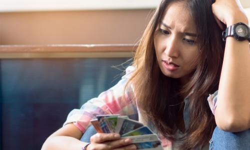 stressed young woman trying to pay credit card debt