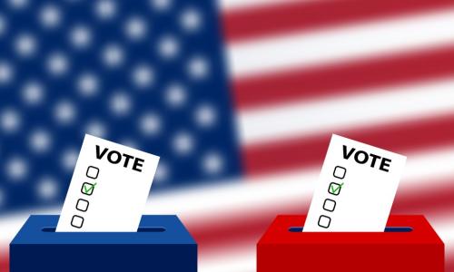 red and blue ballot boxes with an American flag in the background