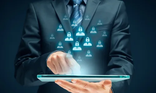 Man holding a glowing tablet with icons of people hovering over it