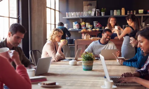 many customers working on laptops at a coffee shop