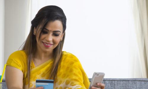 young woman using smart phone to pay 