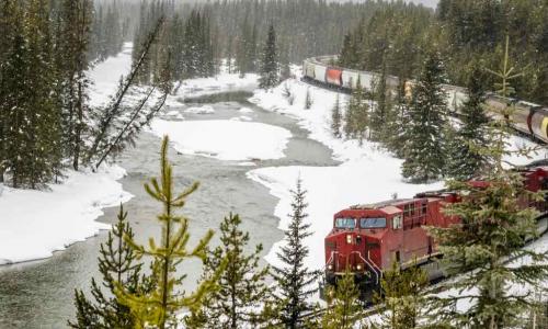 freight train rounding curve in the snow