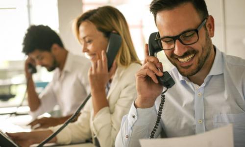 People in operations center talking on landline phone