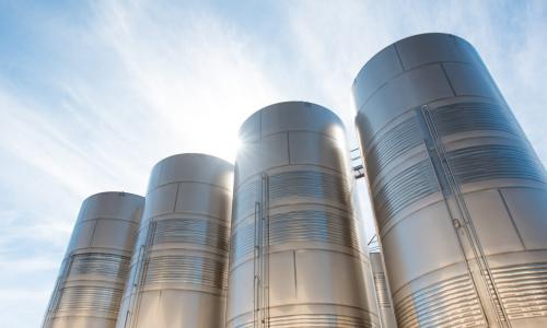 Looking up at a group of industrial siloes