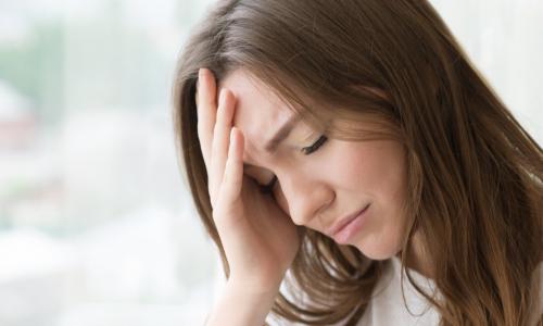 distressed woman holding her head