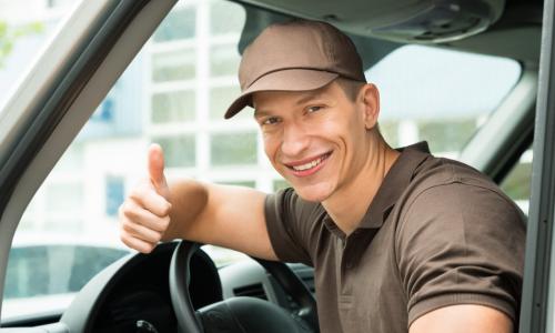 delivery man thumbs up in van