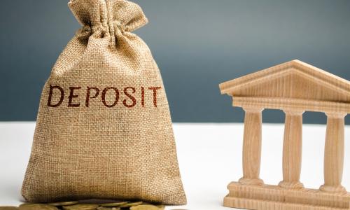 burlap bag with coins and a set of pillars