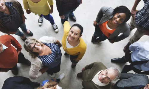 group of diverse people looking up and smiling
