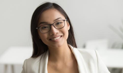 smiling engaged young female employee of Asian descent