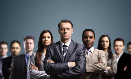 group of directors standing abreast with their arms folded