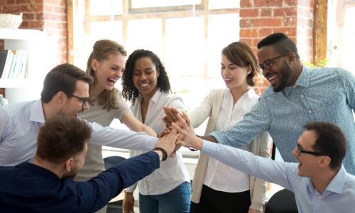 diverse and happy young team of business colleagues high five