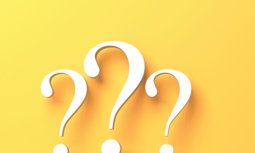 Three yellow question marks on a yellow background 