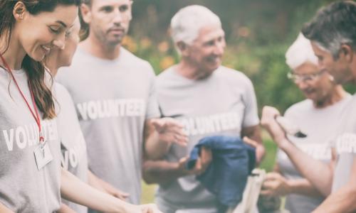 happy credit union volunteers at a community event