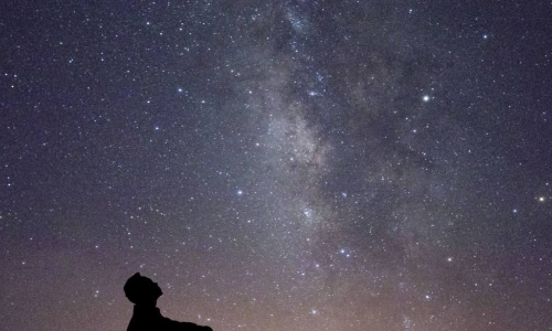 man looking at stars