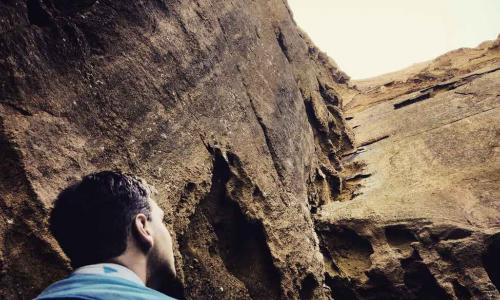 rock climber looks up and assesses climb