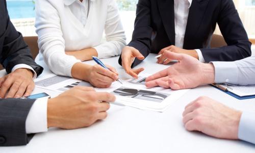 businesspeople reviewing and negotiating vendor contract