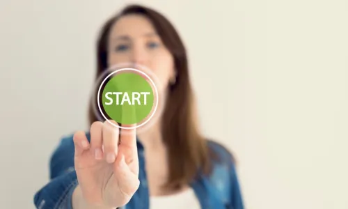 woman presses green start button