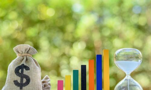 money bag with financial chart blocks and hourglass