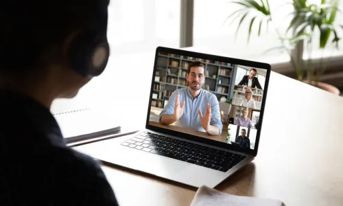 woman in virtual meeting with laptop