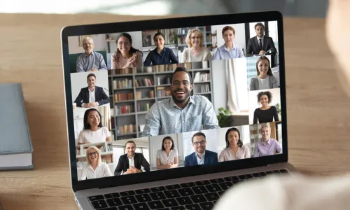 female attends virtual meeting using laptop