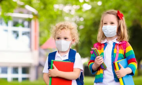 two school girls in masks