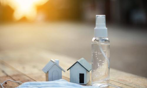 wooden houses with hand sanitizer and mask