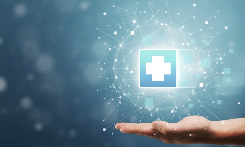 hand holds medical cross symbol