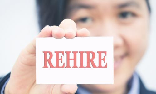 Businesswoman holding card with rehire message