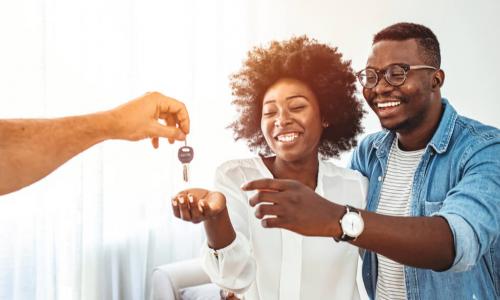 couple getting keys to home