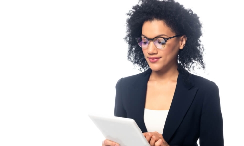 African-American businesswoman wearing glasses using a tablet