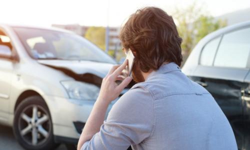 man making call on smartphone after an accident