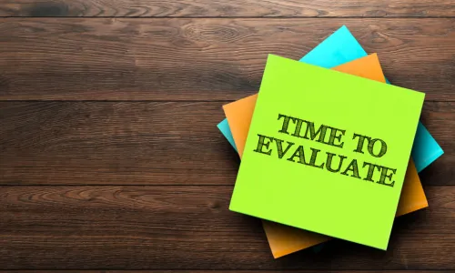 stack of colorful sticky notes with words time to evaluate on top one