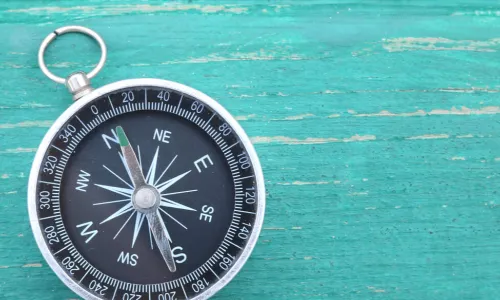 classic round compass on blue background