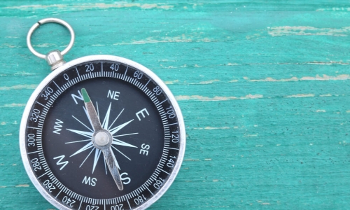 classic round compass on blue background