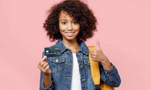 African-American kid with backpack and credit card