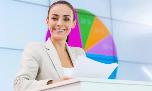 Confident young businesswoman standing at podium smiling before making presentation 
