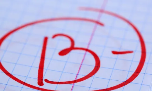 B- grade written on exam paper