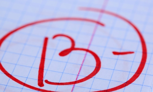 B- grade written on exam paper